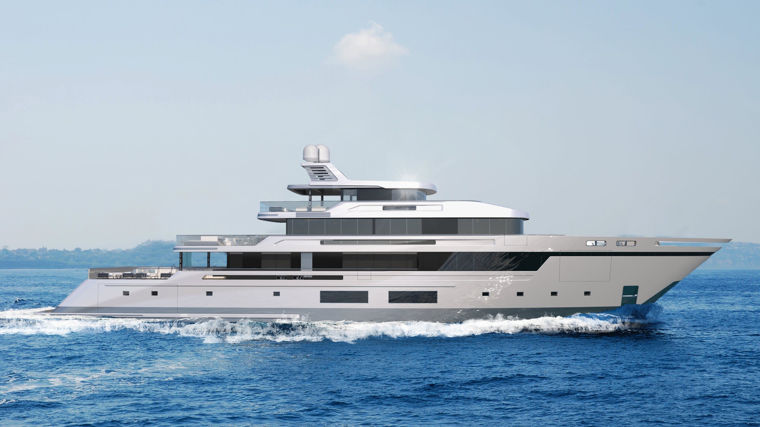 A sleek, modern yacht glides through the azure waters, its white hull cutting through the waves under a clear sky.