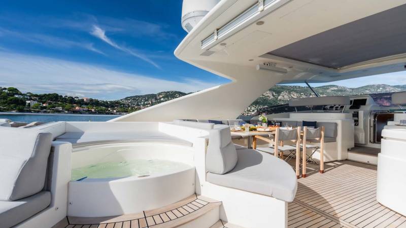 Relax in the jacuzzi or enjoy a meal al fresco on the deck of this luxurious yacht with stunning coastal views.