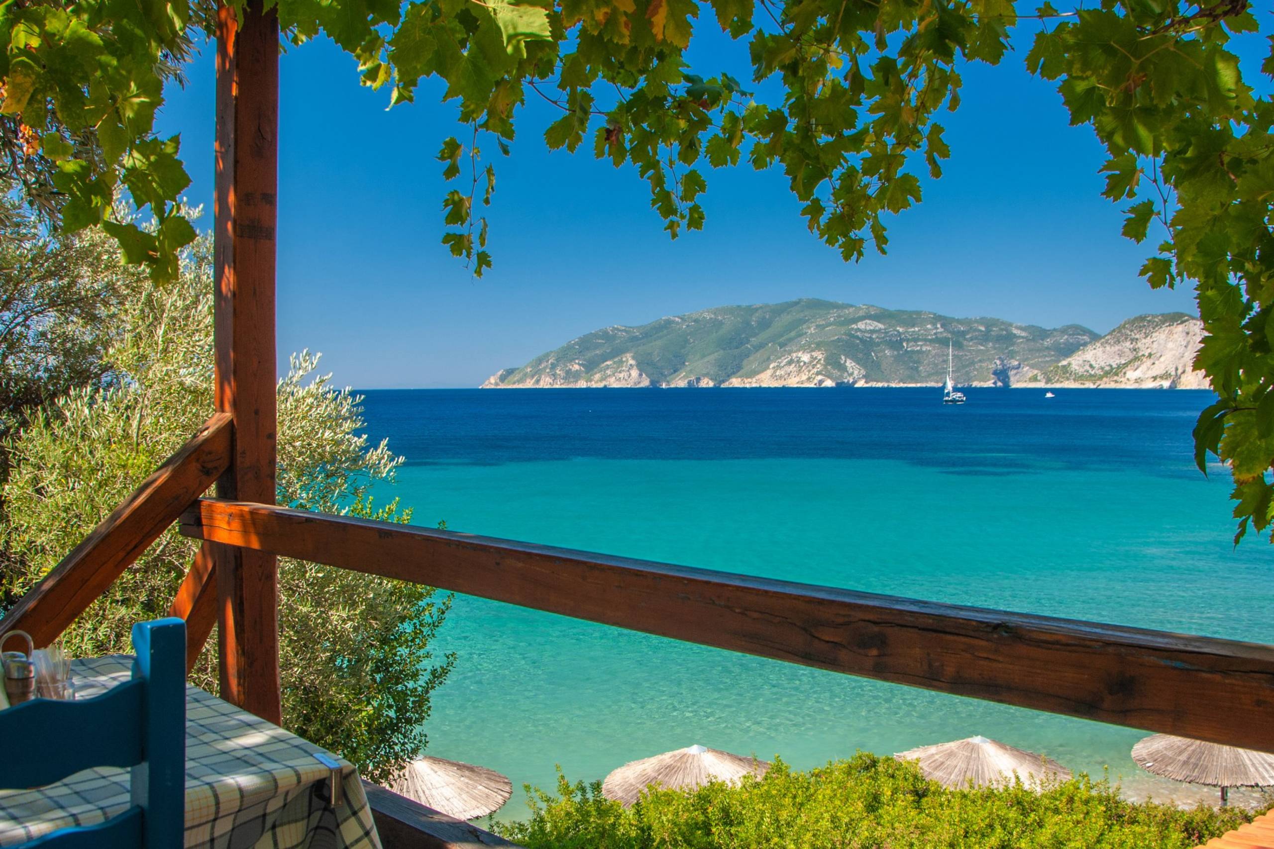 Dine al fresco with a breathtaking view of the turquoise sea and distant island from this charming seaside restaurant.