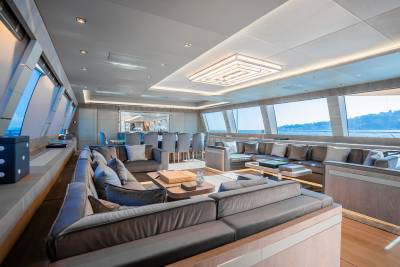 Luxurious yacht interiors feature plush seating and expansive windows offering breathtaking ocean views.