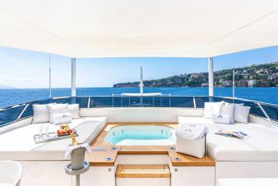 Relax in the jacuzzi on this luxurious yacht with stunning views of the Mediterranean coastline.