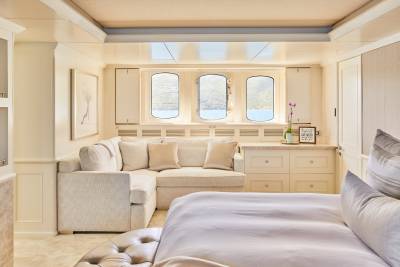 Luxurious yacht interiors offer serene ocean views from plush seating and comfortable beds.
