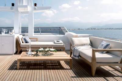 Relax on the luxurious deck of a yacht, enjoying the serene ocean views and a stylish outdoor seating area.