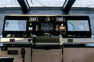 The modern yacht bridge offers a panoramic view of the sea through its advanced navigation and control systems.