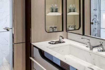 Luxurious marble countertops and sleek chrome fixtures create an elegant and modern bathroom retreat.