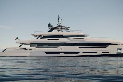 A sleek, modern white yacht glides across calm blue waters under a clear sky.