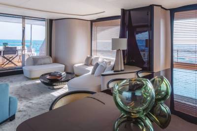 Luxurious yacht interiors offer breathtaking ocean views through expansive windows, blending comfort with the surrounding seascape.