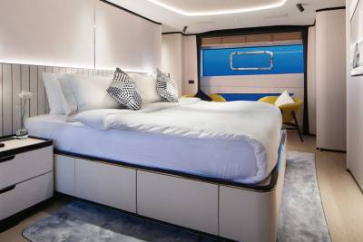 This luxurious yacht cabin offers a serene sleeping space with a unique underwater view.