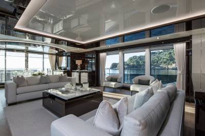 Luxurious yacht interiors open to stunning coastal views, offering a serene and elegant retreat at sea.
