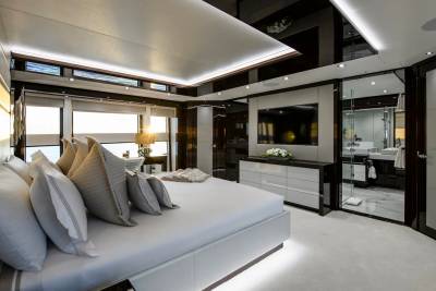 Luxurious yacht bedroom offers stunning ocean views and a sleek, modern en-suite bathroom.