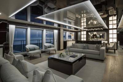 Luxurious yacht interiors offer breathtaking ocean views through expansive windows, complemented by elegant furnishings and a sleek, modern design.