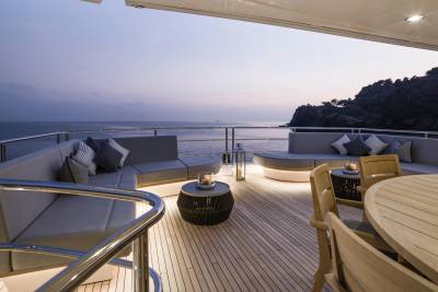 Relax on the deck of this luxurious yacht as the sun sets over the tranquil ocean.