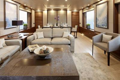 Luxurious yacht interiors offer a serene escape with plush seating, elegant dining, and breathtaking ocean views through expansive windows.