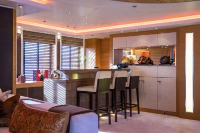 Luxurious yacht interiors feature a sophisticated bar area with elegant seating and ambient lighting.