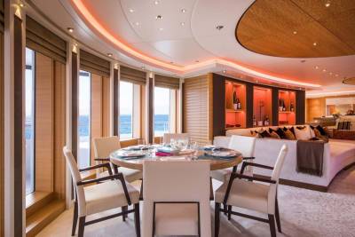 Dine in luxurious comfort overlooking the sparkling blue ocean from this elegant yacht dining room.