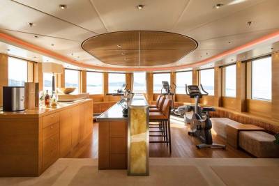 This luxurious yacht gym offers stunning ocean views from its expansive windows and features modern exercise equipment.