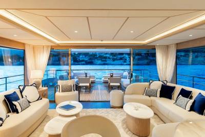 Luxurious yacht interiors blend seamlessly with the azure waters and coastal scenery outside.