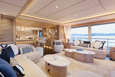 Luxurious yacht interiors blend natural wood tones with plush seating and stunning ocean views.