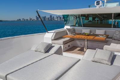 Relax on the spacious deck of this luxury yacht, enjoying the stunning city skyline and turquoise waters.