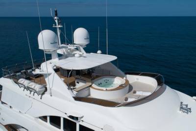Luxurious yacht amenities, including a jacuzzi and sun loungers, offer ultimate relaxation on the open sea.