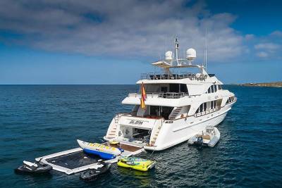 A luxurious yacht, the Elena, is anchored offshore with various water toys ready for adventure.