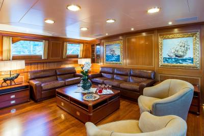 Luxurious leather sofas and plush armchairs create a comfortable seating area within this elegantly appointed yacht salon.
