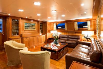 Luxurious leather sofas and plush armchairs create a warm and inviting ambiance in this elegantly appointed yacht salon.
