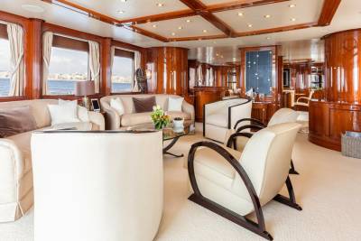Luxurious wood paneling and plush seating create an elegant salon aboard this opulent yacht.