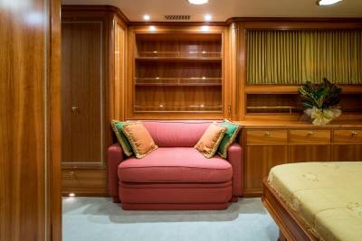 Luxurious wood paneling and plush furnishings create an inviting retreat within this elegant yacht cabin.