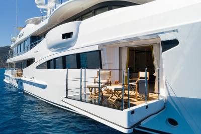 Luxurious yacht decks offer a serene escape with comfortable seating and refreshing drinks overlooking the azure sea.