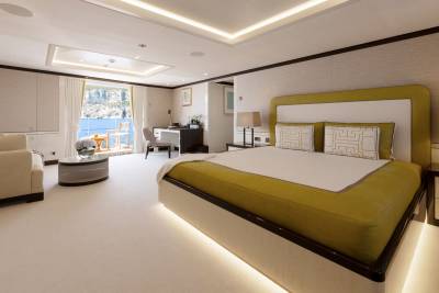 Luxurious yacht stateroom offers a serene retreat with stunning ocean views and elegant furnishings.
