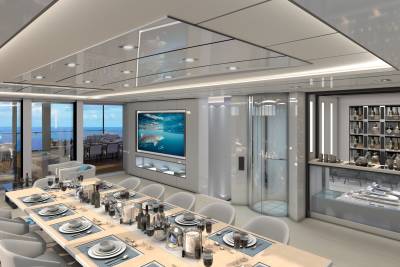 A luxurious yacht dining room features a large screen displaying underwater life, a modern bar, and an impressive model yacht display.