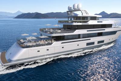 A sleek, modern yacht glides through sparkling blue waters, its multiple decks offering luxurious outdoor seating and panoramic views of distant mountains.