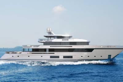 A sleek, modern yacht glides through the azure ocean, leaving a foamy wake under a clear sky.