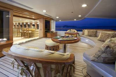 Enjoy a twilight cocktail and gourmet snacks on this luxurious yacht deck overlooking the serene ocean.