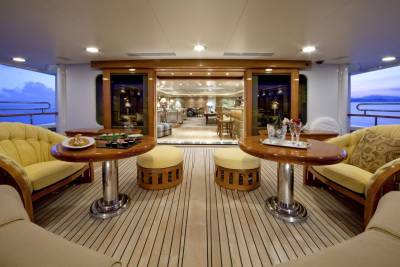 Enjoy a luxurious evening on deck with champagne and sushi as the sun sets over the ocean.