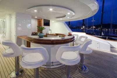 Enjoy cocktails at this elegant yacht bar overlooking a serene harbor at dusk.