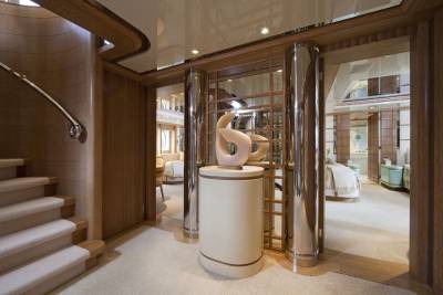 An elegant sculpture stands proudly in the hallway of this luxurious yacht, hinting at the opulence within.