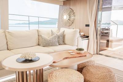 Relax in this serene yacht lounge with its natural textures and expansive views of the water.