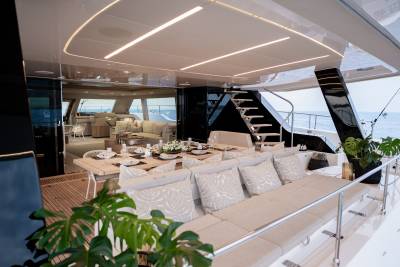 Dine al fresco on the deck of this luxurious yacht, surrounded by plush seating and the open sea.