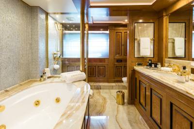 Luxurious wooden cabinetry and marble accents create a lavish bathroom oasis on this yacht.
