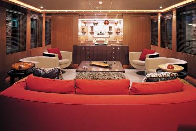 Luxurious red seating and unique decor create a sophisticated lounge aboard this opulent yacht.