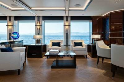 Luxurious yacht interiors offer breathtaking ocean views from plush seating areas.