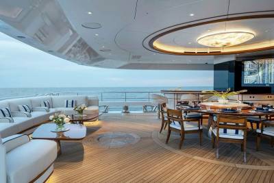 Luxurious yacht deck seating and dining areas offer an elegant space for enjoying the ocean breeze and stunning sea views.