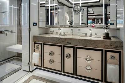 Luxurious marble countertops and sleek cabinetry create a spa-like ambiance in this elegant yacht bathroom.
