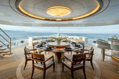 Dine al fresco on this luxurious yacht's deck, surrounded by the endless blue ocean and elegant furnishings.