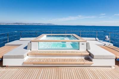 Relax in the crystal-clear waters of this luxurious yacht's infinity pool overlooking the azure Mediterranean Sea.