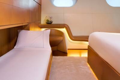 Luxurious cabins offer a serene retreat with plush bedding and warm, ambient lighting.