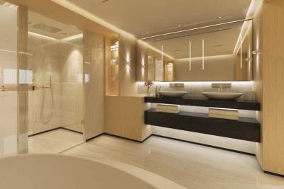 Luxurious bathroom features a spacious glass-enclosed shower, dual vessel sinks, and warm wood accents illuminated by soft, ambient lighting.