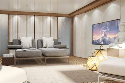 Relax in this serene lounge area featuring comfortable seating, ambient lighting, and a large screen for entertainment.